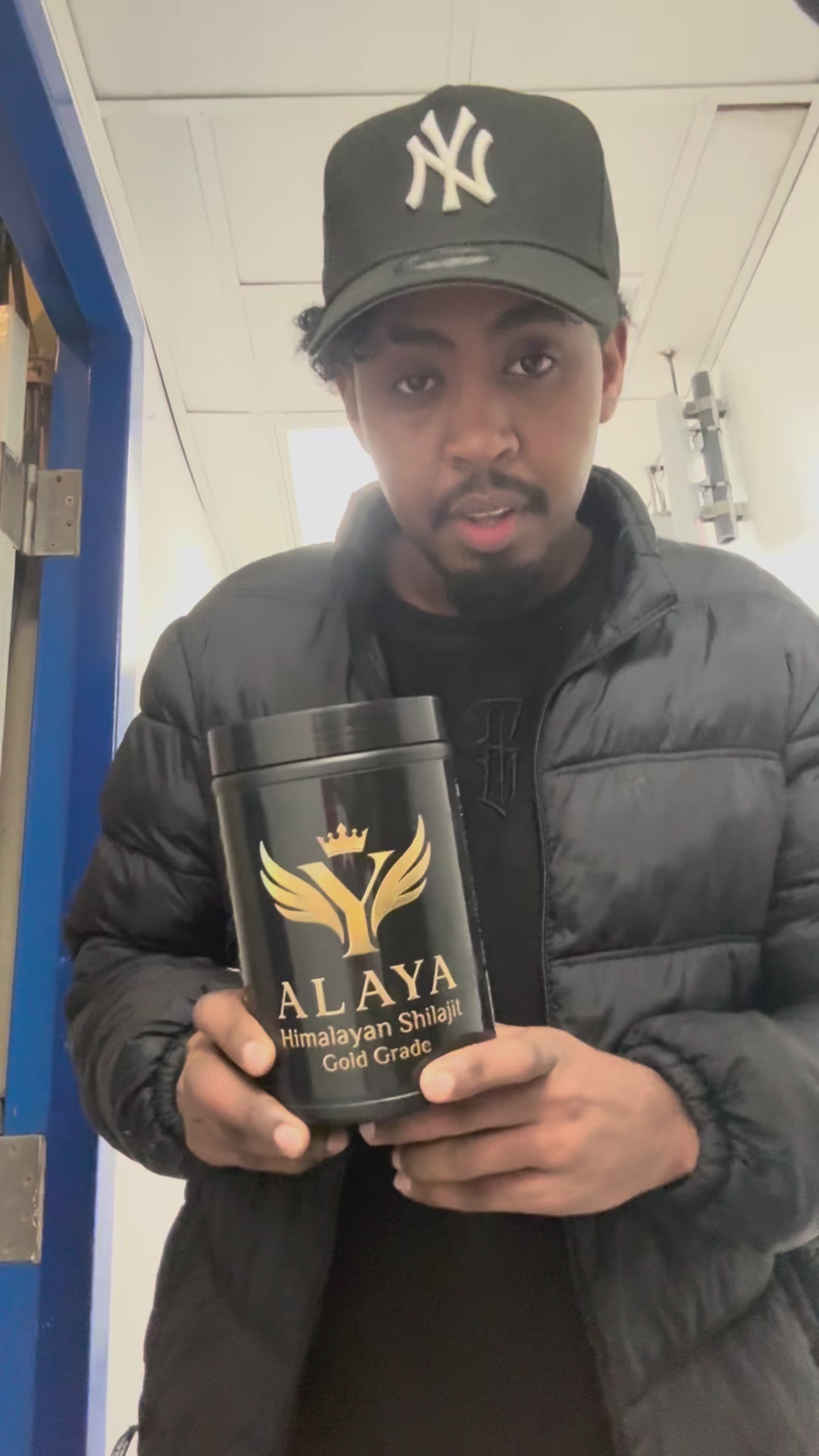 Man holding Alaya Shilajit Gold Grade jar, sharing testimonials about brain power, memory, and mental focus with subtitles.