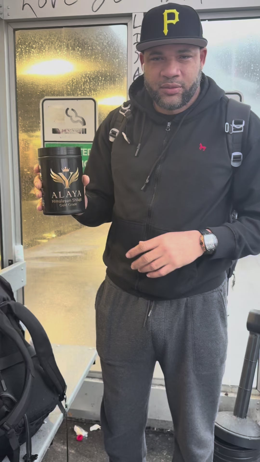 Young man outdoors recommending Alaya Shilajit as a 100% natural supplement for daily vitality and strength.